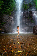 Tourist woman near Munduk waterfall, Bali, Indonesia