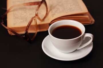 A cup of coffee and a book