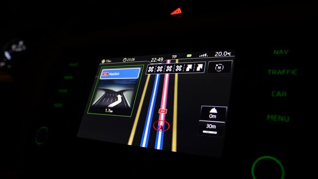 View of car dashboard at night driving with destination Haarlem on the A4 highway with exit on the A5 - modern autonomous car driving - gps