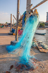 after the fish is caught, a fishing net is maintained directly at the pier, arranged and hung on a...
