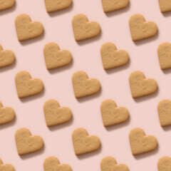 Valentine's day seamless pattern with homemade heart shaped cookies on pink background.