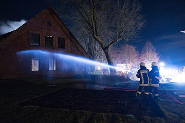 Feuerwehrmann löscht Gebäude mit Kellerbrand