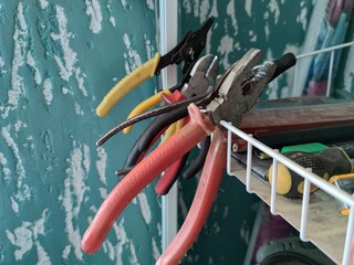 Various construction or craft tools at home on a shelf.