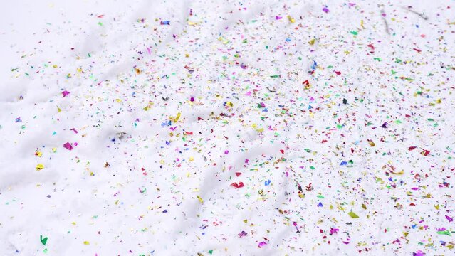 Beautiful colorful bright multicolor confetti and white snowy Christmas, Xmas or New Year celebration abstract 4k stock video background