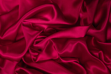 Rich and luxury red silk fabric texture background.