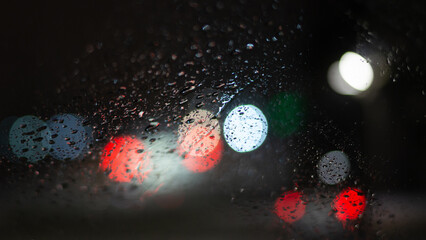 Blurred background with raindrops and lights.