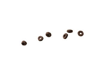 Chocolate rings cereal spill out into a bowl. Breakfast.