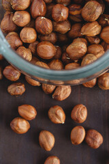 Close up brown hazel nut in glass jar and on wooden desk. Healthy organic vegetarian snack hazelnut