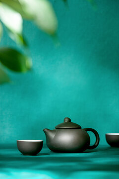 Natural green tea concept, dark teapot, and tea bowls