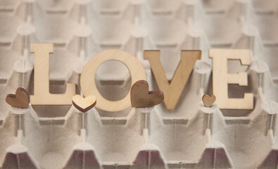 Love word, small hearts on abstract background. Happy Valentine's Day.