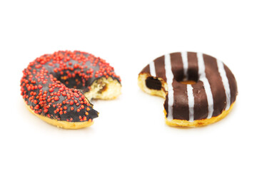 Bitten donut with colorful sprinkles and filling isolated on white background. Top view.