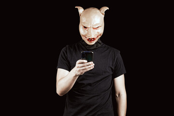 Portrait of an anonymous man wearing pig mask. Person writing abusive messages. Social media...