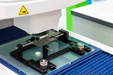 Close up workpiece during inspection dimension shape appearance etc. by high technology precision video measuring machine with visual camera for quality control of manufacturing process