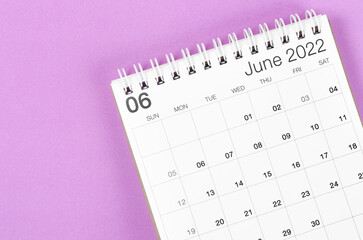 June 2022 desk calendar on light purple background.