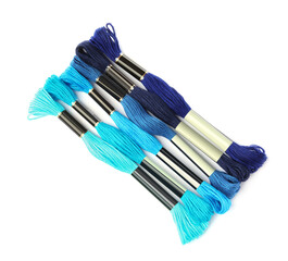 Set of colorful embroidery threads on white background, top view