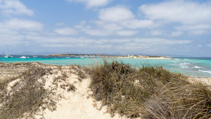The islet of Espalmador with sand dunes is part of the Natural Park of the Salinas of Ibiza and Formentera. Concept of tourism, ecosystem and environmentalism