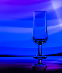 Glass tumbler on a colored background
