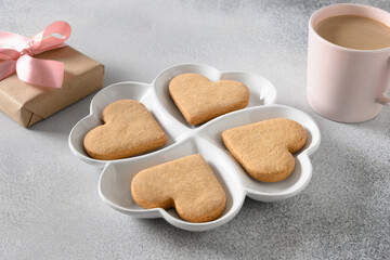 Valentine's Day coffee, heart shaped cookies for romantic breakfast on gray background. Close up.