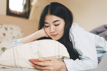 Young adult single woman using smartphone in the morning for online app mental health.
