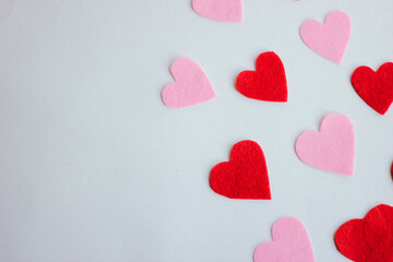 Fototapeta premium Paper hearts over the wight background. Abstract background with paper cut shapes.