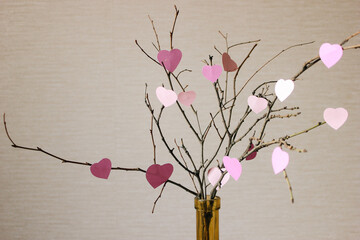Happy Valentine's Day. Roze elements hanging on the branch for invitation or poster. © Yekaterina