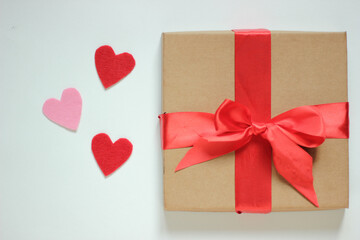 Paper art Valentine's day concept banner with hand made gift box and a lot of hearts on a wight background
