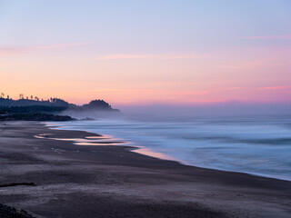Lincoln beach with smooth wave and sunrise sky abstract background. Copy space of business summer vacation and travel adventure concept long exposure photograph.