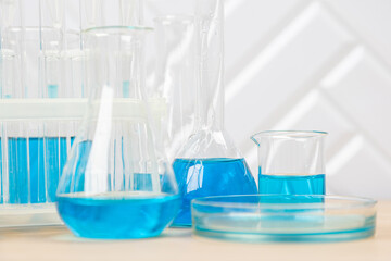 Laboratory glassware with blue liquid in a test tube. scientific laboratory flasks, droppers, Petri dishes, beakers and cylinders, laboratory equipment