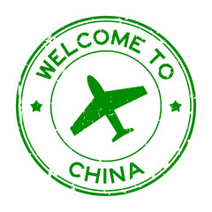 Grunge green welcome to China word with airplane icon round rubber seal stamp on white background