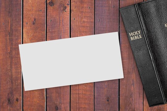 Concept of message on wooden background with closed Bible. God Jesus Christ