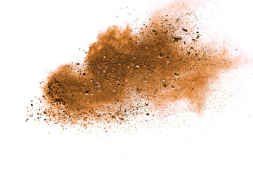 Abstract brown powder explosion. Closeup of brown dust particle splash isolated on white  background