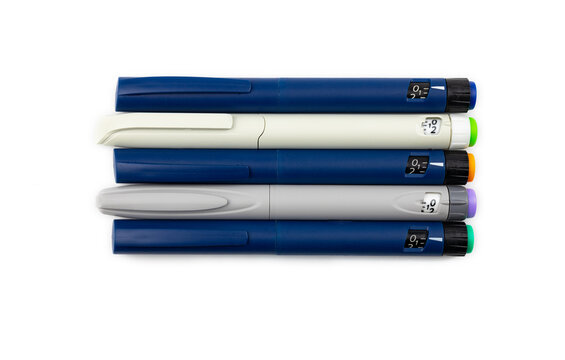 Colored Insulin Pens On A White Background, Top View. 