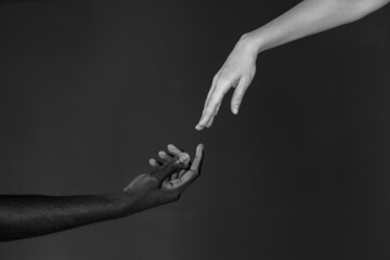 Black and white male and female hands in black and white photo. Black and white photography. All Lives matter concept
