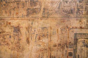 Fototapeta na wymiar Stone slab with Egyptian hieroglyphs with spots, scratches and flaws