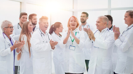 Obraz na płótnie Canvas group of diverse smiling doctors applauding together.