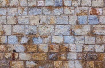 Stone wall made of natural stone. Background of antique, masonry.