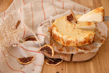 Unrecognizable person is holding a piece of cheesecake.  Hand chooses a slice of cake on a Christmas table. juicy cheesecake baked by hand by professional pastry woman