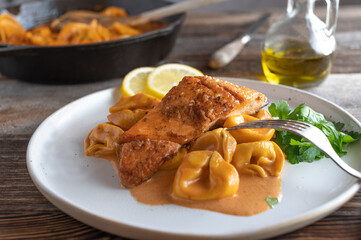 Roasted salmon with pasta and tomato cream sauce