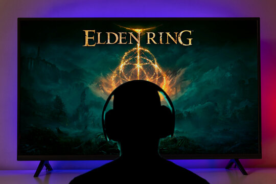Man with headphones playing Elden Ring at TV Screen, selective focus, 27 Jan, 2022, Sao Paulo, Brazil.