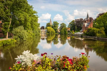 Papier Peint photo Lavable Brugges View to Minnewaterpark at Bruges, Belgium - Artificial lake surrounded by trees, flowers and old buildings