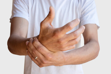 Fototapeta premium Carpal tunnel syndrome, arthritis. Arms holding painful wrist. Work on the computer, laptop. Closeup. Numbness of the hand