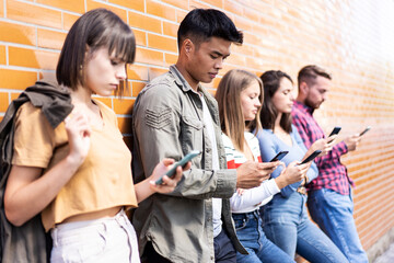 Multicultural people group using smartphone at university college backyard - Milenial friends...