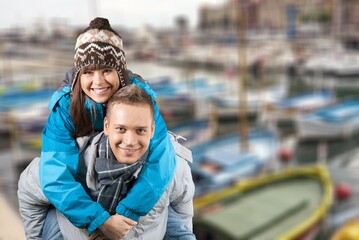 Fototapeta na wymiar Smiling man and happy woman in the city. Young multiethnic couple in cold clothes walking