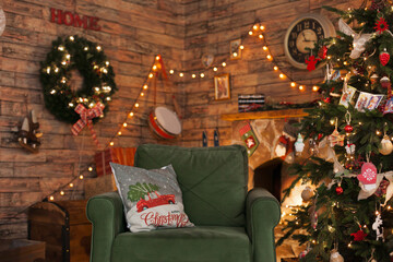 Cozy living room with armchair and fireplace decorated for winter holiday season with a christmas tree and lights. Interior of a room on christmas holiday season.
