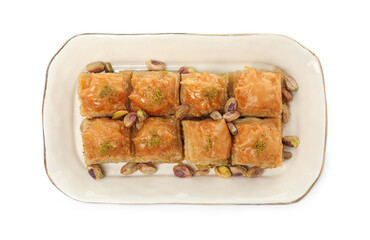 Plate of delicious baklava with pistachio nuts on white background, top view