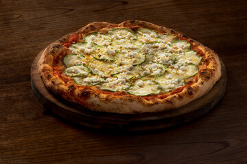 Delicious italian vegetarian pizza of Courgette at wooden table background