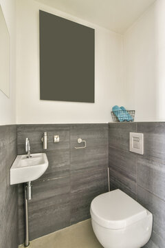 Interior of lavatory rom with toilet bowl and sink