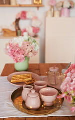 Pink kitchen. Studio apartment. Loft interior. Shelves and spring decor in room. Rent and delivery of housing. Hostel and hotel. Valentine's day, mother's day
