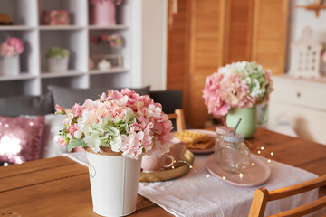 Pink kitchen. Studio apartment. Loft interior. Shelves and spring decor in room. Rent and delivery of housing. Hostel and hotel. Valentine's day, mother's day
