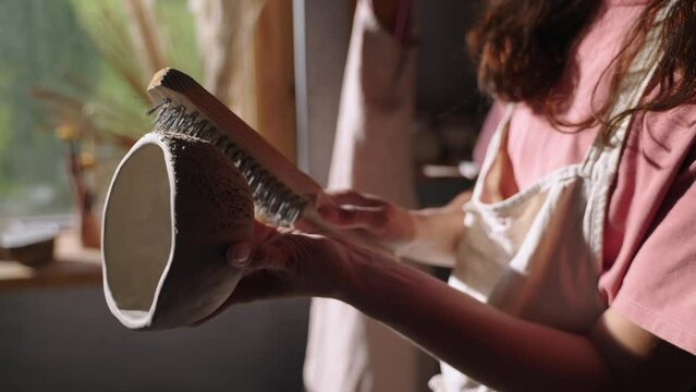 Artisan creating texture on a handmade ceramic bowl